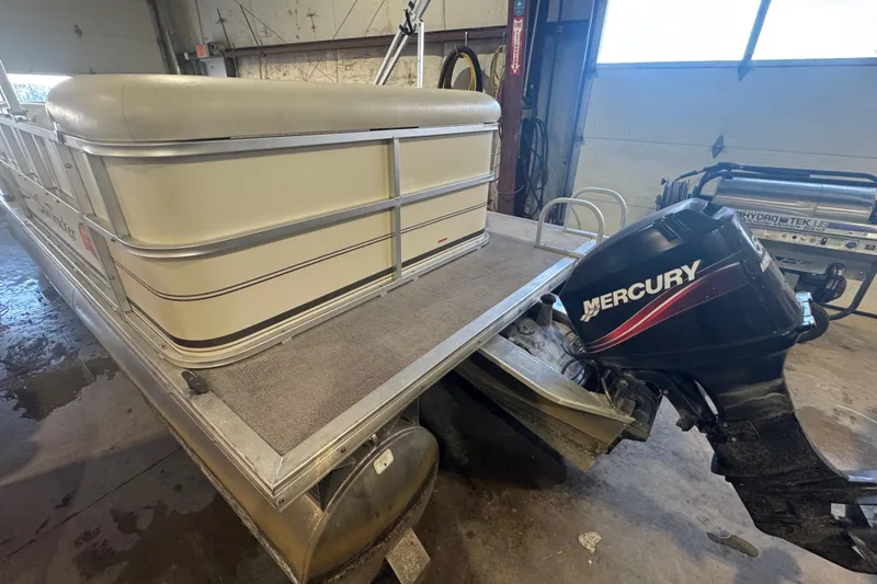 Slide: The Image of 2008 Sun Tracker Party Barge 200 Classic Series with Mercury outboard motor in garage. - 5