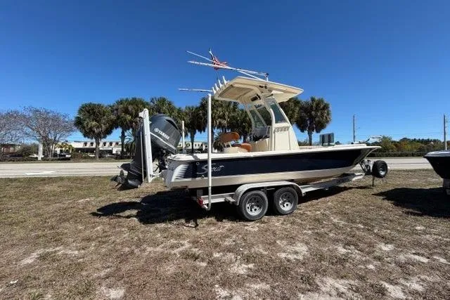 Slide: The Image of 2014 Scout 251 XS boat on trailer under clear blue sky. - 1
