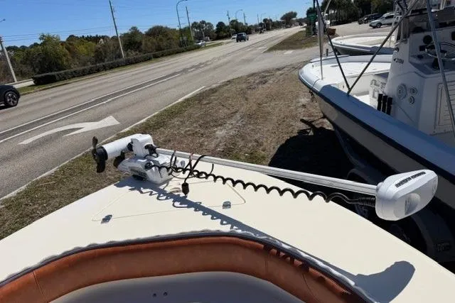 Slide: The Image of 2014 Scout 251 XS boat with trolling motor on a sunny day near a road. - 13