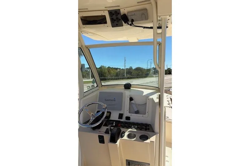 Slide: The Image of 2014 Scout 251 XS boat dashboard with Garmin navigation system and steering wheel. - 16