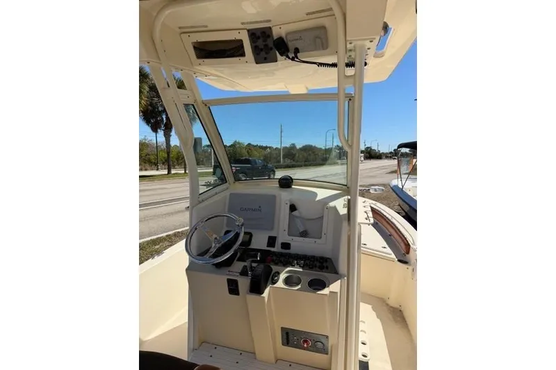 Slide: The Image of 2014 Scout 251 XS boat cockpit with steering wheel and Garmin navigation system. - 17