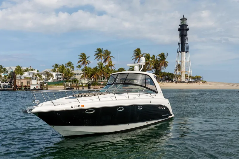 Slide: The Image of 2008 Chaparral Signature 350 yacht near a lighthouse and palm trees. - 1