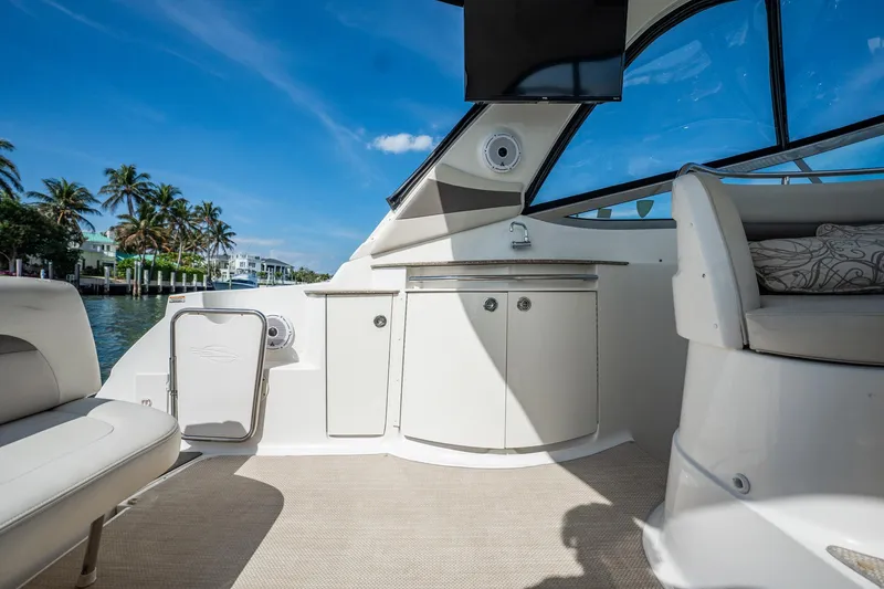 Slide: The Image of 2008 Chaparral Signature 350 boat interior with seating, cabinets, and waterfront view. - 12