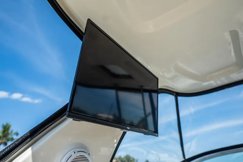 Slide: The Image of Flat-screen TV on 2008 Chaparral Signature 350 boat, blue sky background. - 14