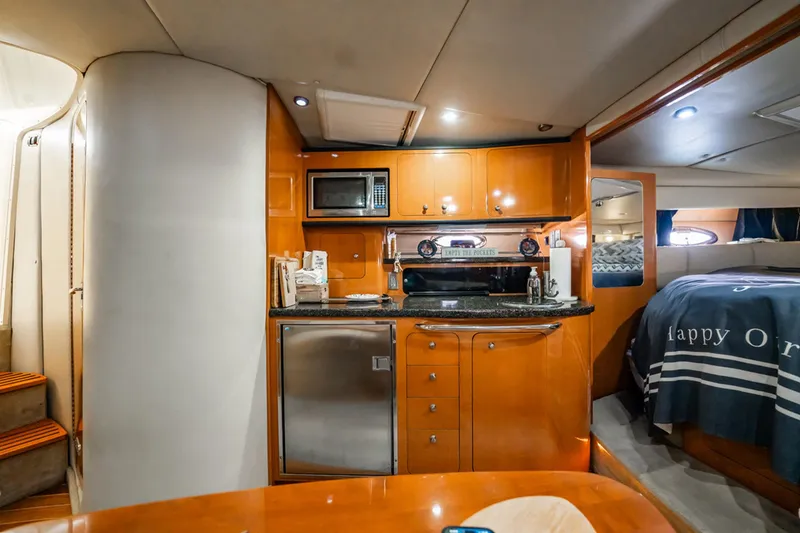 Slide: The Image of 2008 Chaparral Signature 350 yacht interior with kitchen, microwave, and cozy sleeping area. - 17
