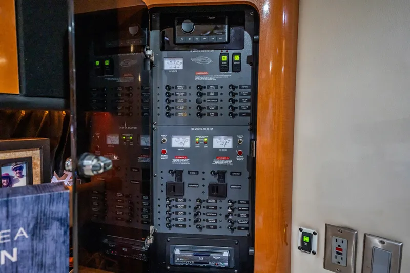 Slide: The Image of Electrical control panel inside 2008 Chaparral Signature 350 yacht, featuring various switches and indicators. - 24