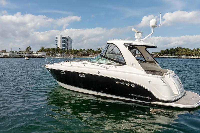 Slide: The Image of 2008 Chaparral Signature 350 boat on water, with cityscape and palm trees in background. - 3