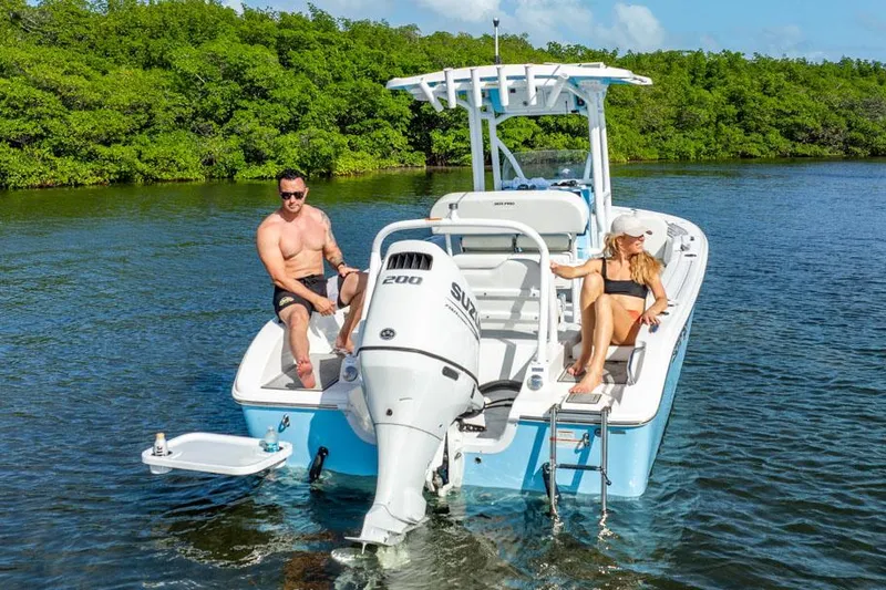 Slide: The Image of Manufacturer Provided Image: 2025 Sea Pro 225FLX Sandbar boat with two people relaxing on water. - 11