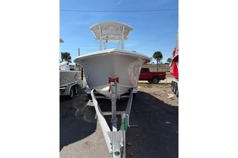 Slide: The Image of 2026 Sea Pro 225FLXR Sandbar boat on trailer, parked outdoors under clear sky. - 2