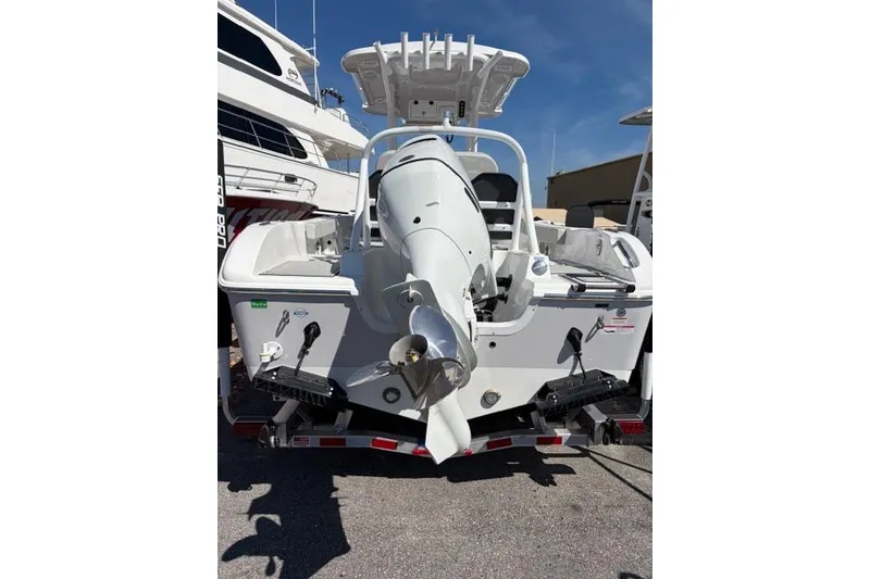 Slide: The Image of 2026 Sea Pro 225FLXR Sandbar boat, rear view with outboard motor, parked on trailer. - 8