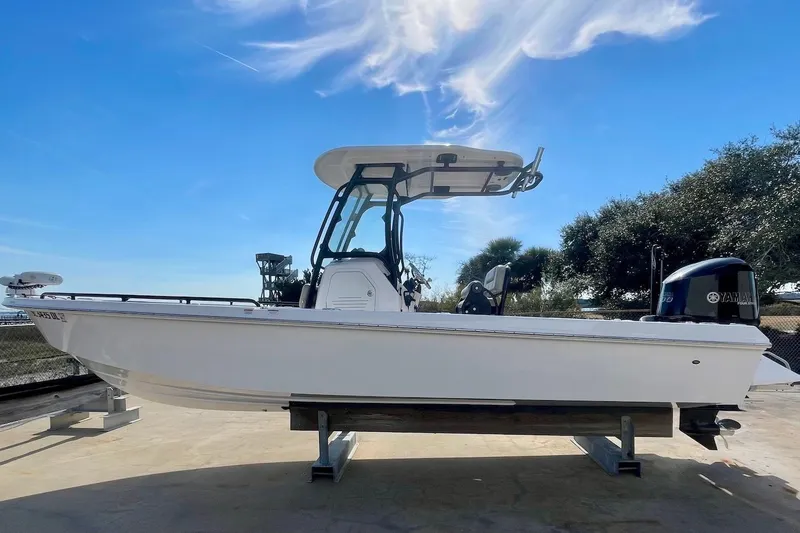 The Image of 2019 Everglades 243 Center Console boat on display under a clear blue sky. - 0
