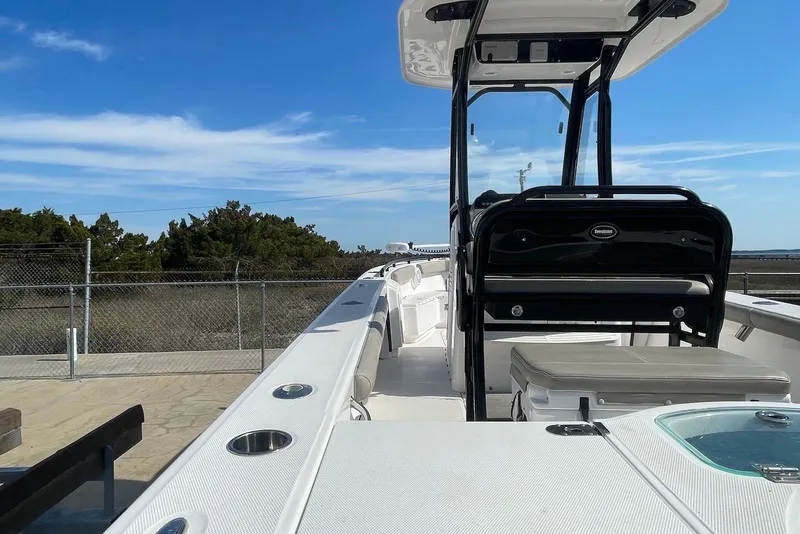Slide: The Image of 2019 Everglades 243 Center Console boat docked, showcasing sleek design and spacious deck. - 10