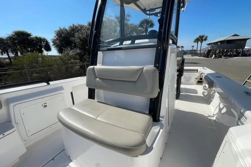 Slide: The Image of 2019 Everglades 243 Center Console boat interior with seating and console, dockside view. - 11