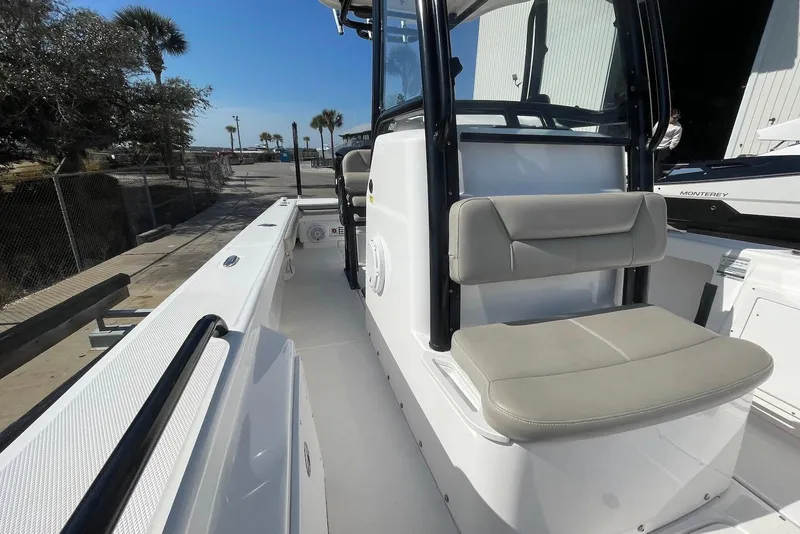 Slide: The Image of 2019 Everglades 243 Center Console boat with seating, docked near palm trees. - 12