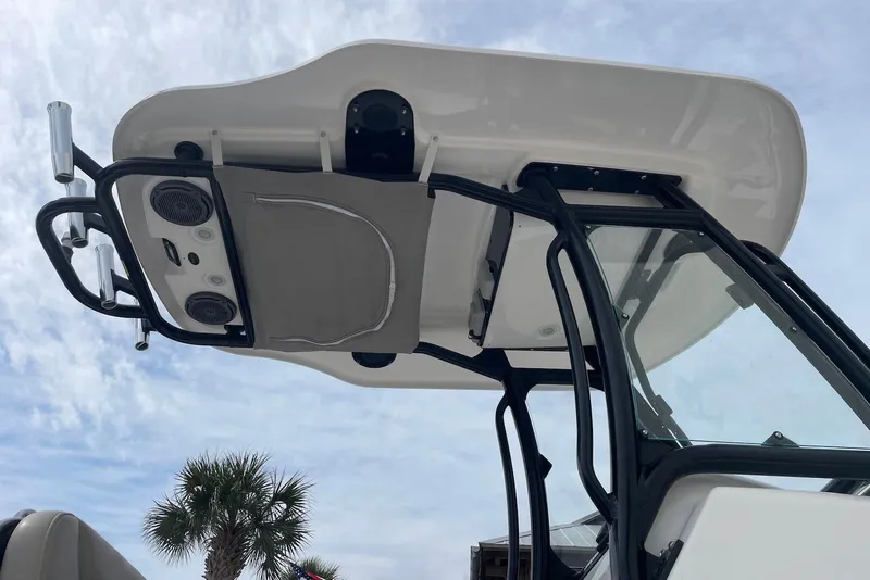Slide: The Image of 2019 Everglades 243 Center Console boat with T-top and rod holders against a cloudy sky. - 18