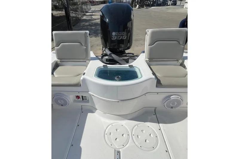 Slide: The Image of 2019 Everglades 243 Center Console boat with Yamaha 300 engine, featuring seating and storage. - 19