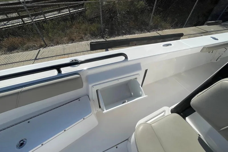 Slide: The Image of 2019 Everglades 243 Center Console boat interior with seating and storage compartment. - 21