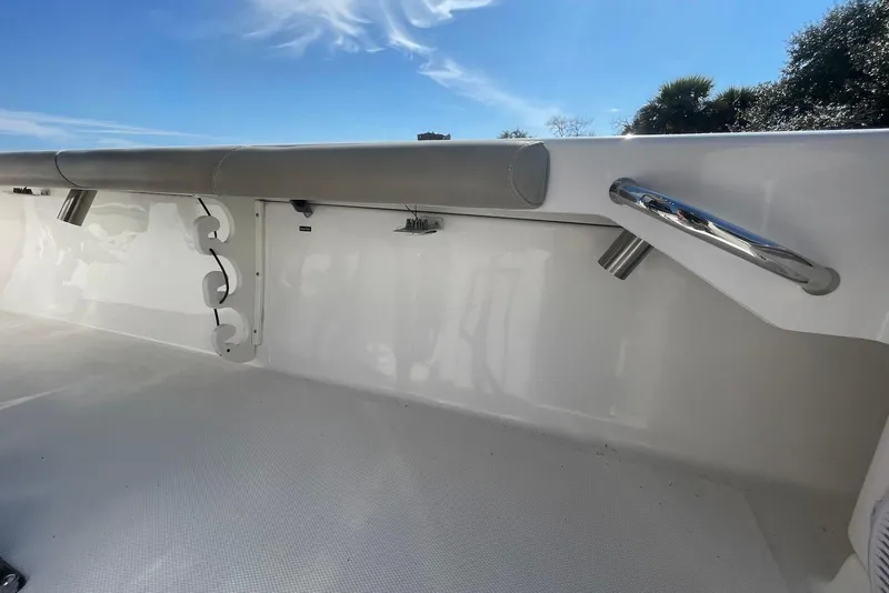 Slide: The Image of 2019 Everglades 243 Center Console interior with rod holders and stainless steel rail. - 22