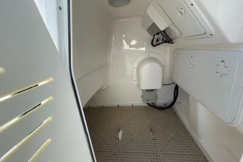 Slide: The Image of 2019 Everglades 243 Center Console interior storage compartment with wiring and access panels. - 24