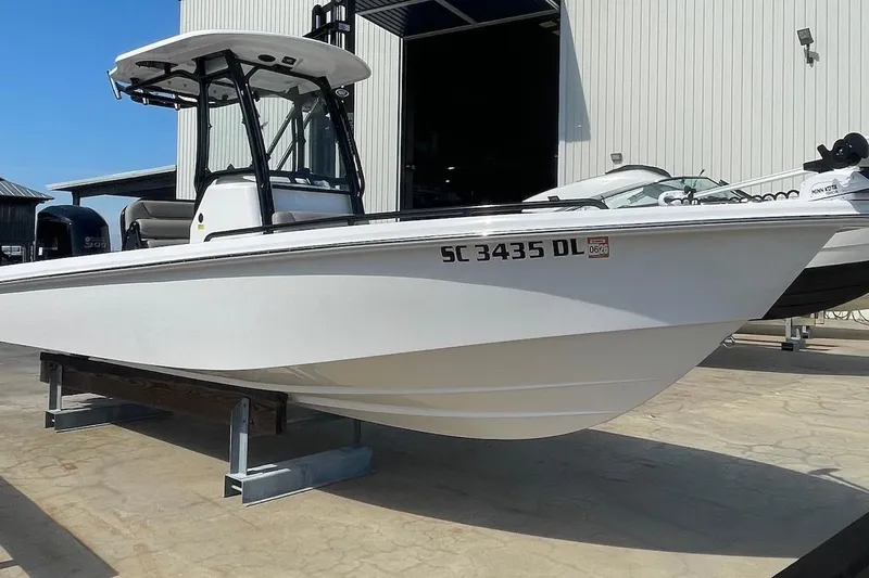 Slide: The Image of 2019 Everglades 243 Center Console boat on display outside a warehouse. - 3