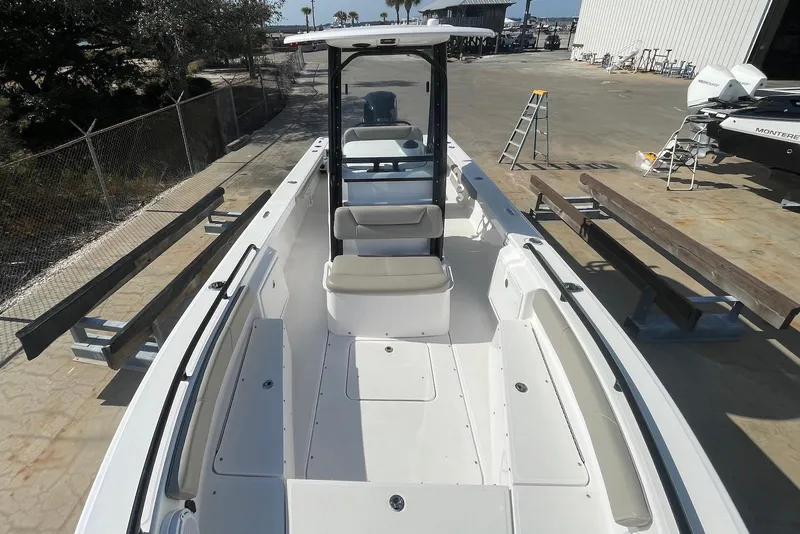 Slide: The Image of 2019 Everglades 243 Center Console boat docked, showcasing spacious seating and sleek design. - 6