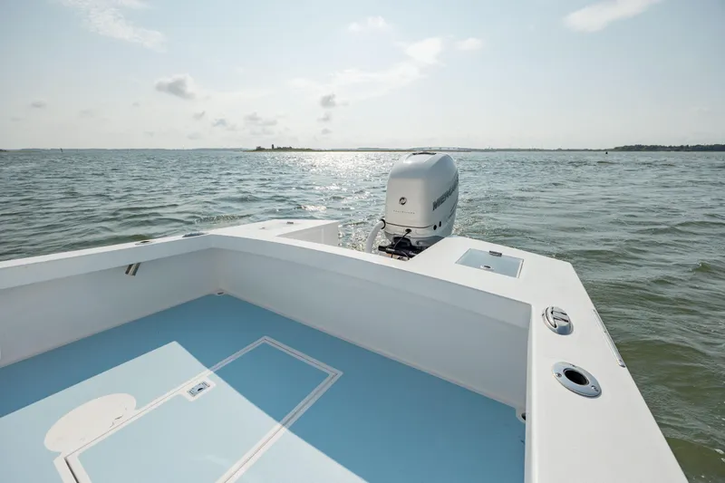 Slide: The Image of 2019 Gamefisherman 26 Cuddy Cabin boat on open water, featuring a sleek design. - 11
