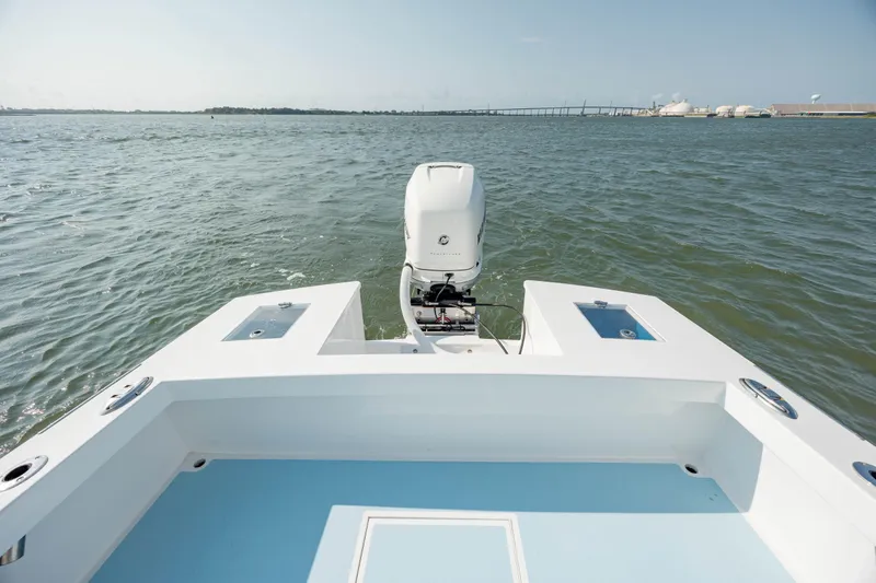 Slide: The Image of 2019 Gamefisherman 26 Cuddy Cabin boat on open water, rear view. - 12