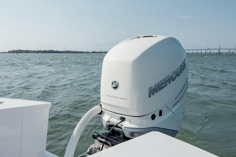 Slide: The Image of 2019 Gamefisherman 26 Cuddy Cabin with Mercury outboard engine on open water. - 13