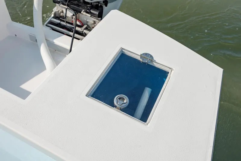 Slide: The Image of 2019 Gamefisherman 26 Cuddy Cabin boat deck with hatch and engine view. - 14