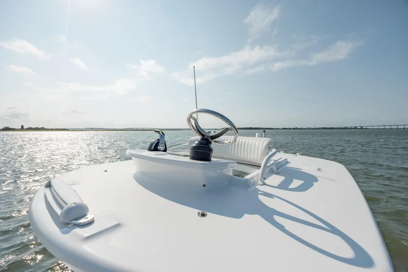 Slide: The Image of 2019 Gamefisherman 26 Cuddy Cabin boat on open water, sunny day, clear sky. - 24