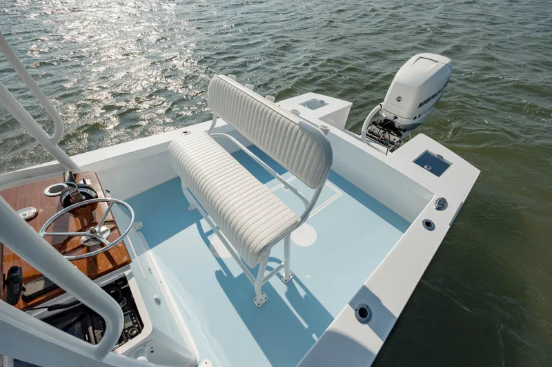 Slide: The Image of 2019 Gamefisherman 26 Cuddy Cabin boat with outboard motor on water. - 25