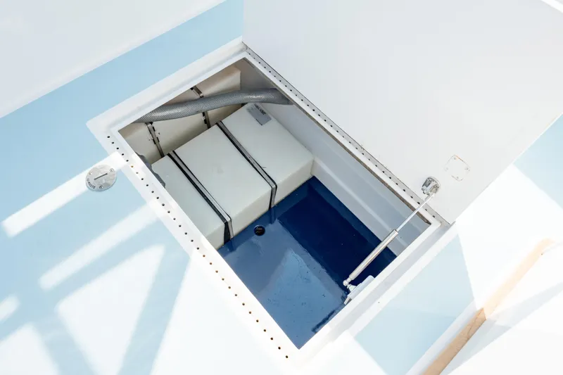 Slide: The Image of Open storage compartment on 2019 Gamefisherman 26 Cuddy Cabin boat. - 30