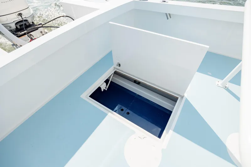 Slide: The Image of Open storage compartment on 2019 Gamefisherman 26 Cuddy Cabin boat deck. - 31