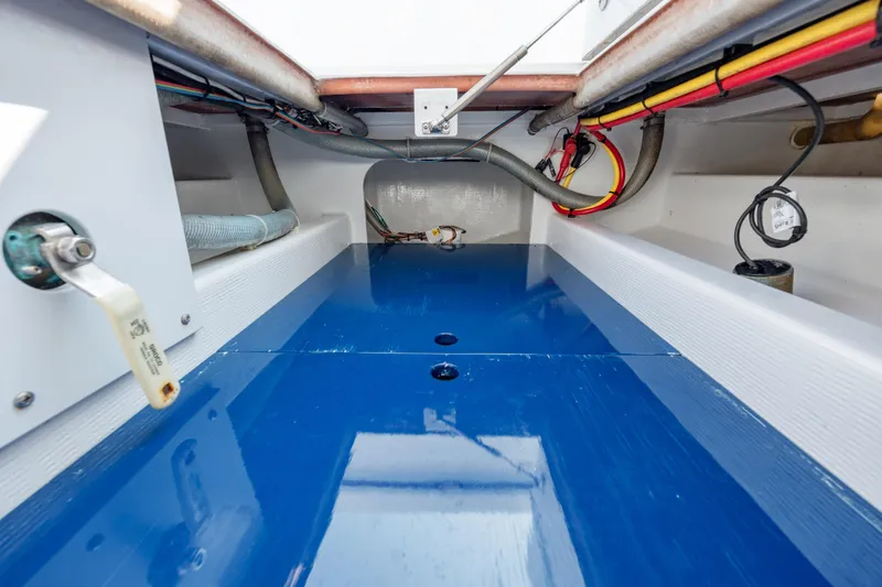 Slide: The Image of 2019 Gamefisherman 26 Cuddy Cabin interior with blue flooring and visible wiring. - 32