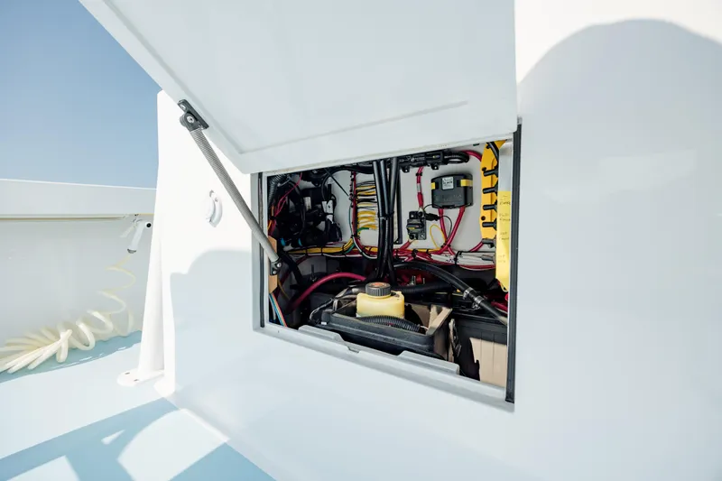Slide: The Image of Engine compartment of 2019 Gamefisherman 26 Cuddy Cabin, showcasing wiring and components. - 33