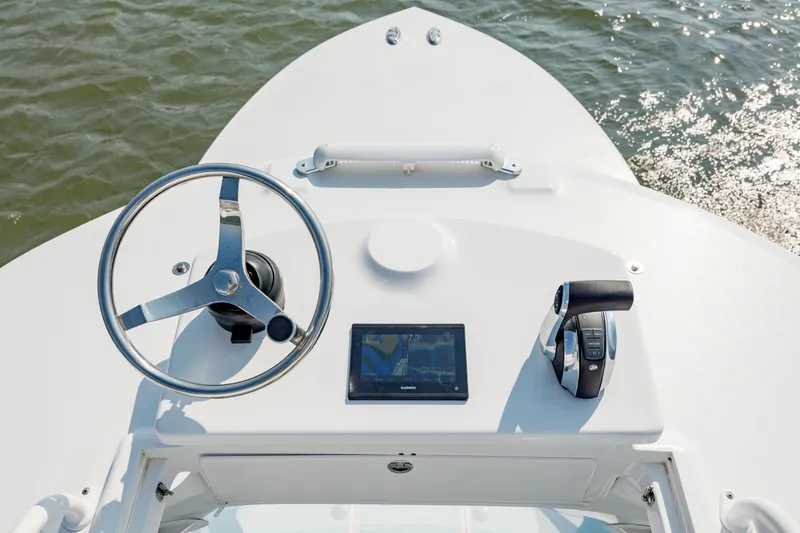 Slide: The Image of 2019 Gamefisherman 26 Cuddy Cabin helm with steering wheel and navigation system. - 35