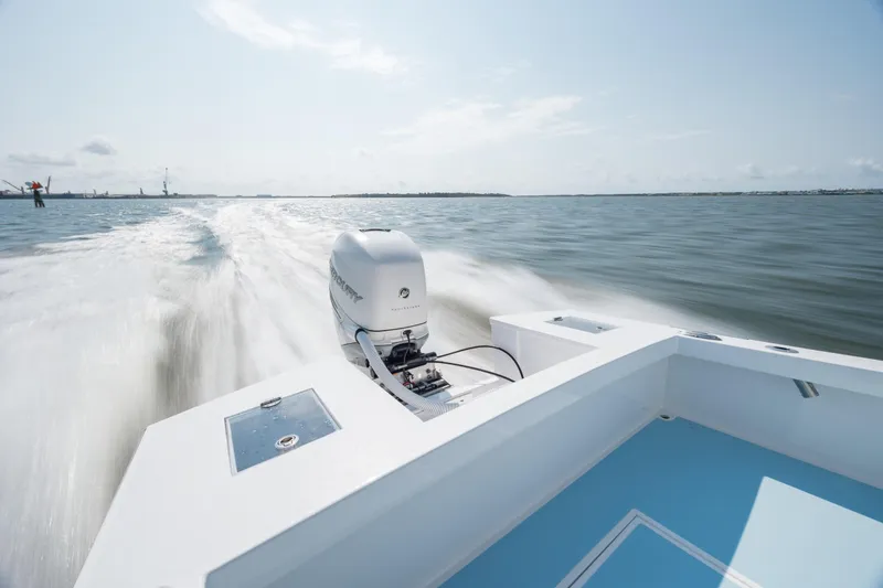 Slide: The Image of 2019 Gamefisherman 26 Cuddy Cabin speeding on open water, showcasing powerful outboard engine. - 40