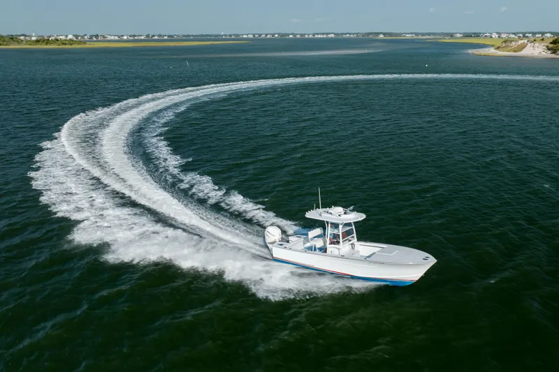 Slide: The Image of 2019 Gamefisherman 26 Cuddy Cabin making a sharp turn on open water. - 49