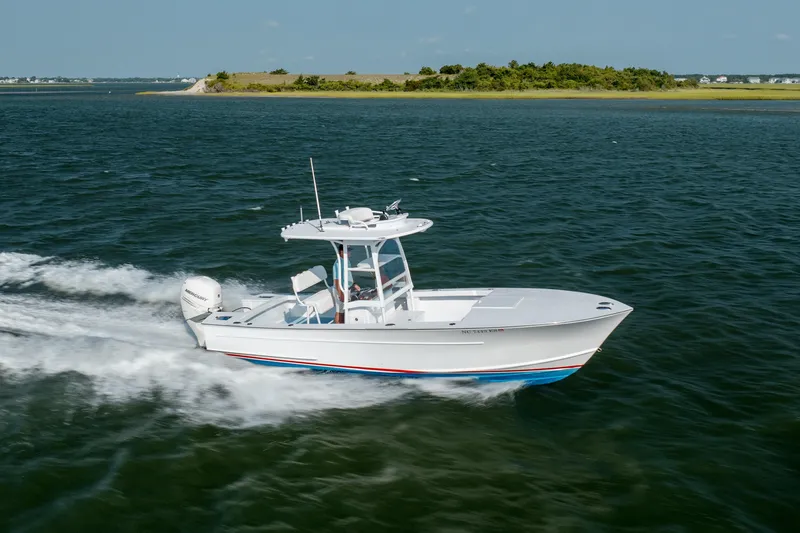 Slide: The Image of 2019 Gamefisherman 26 Cuddy Cabin cruising on open water, showcasing sleek design and performance. - 56
