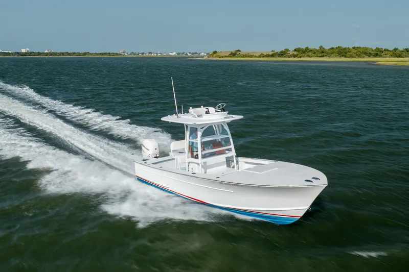 Slide: The Image of 2019 Gamefisherman 26 Cuddy Cabin cruising on open water, showcasing sleek design and performance. - 57