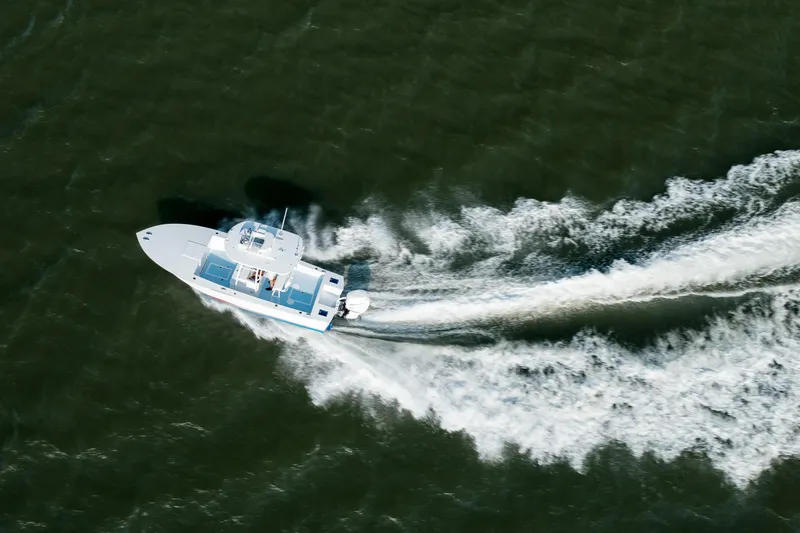 Slide: The Image of Aerial view of 2019 Gamefisherman 26 Cuddy Cabin cruising on open water. - 59