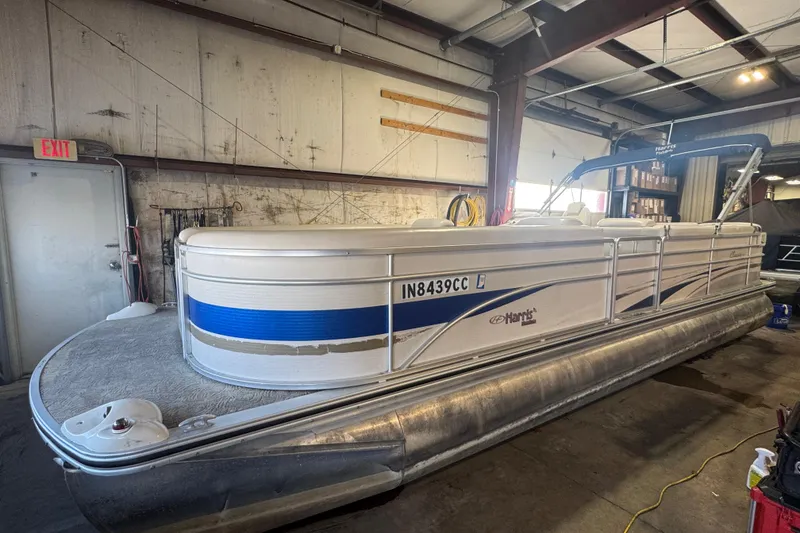 Slide: The Image of 2005 Harris FloteBote 260 Classic pontoon boat in a warehouse setting. - 1