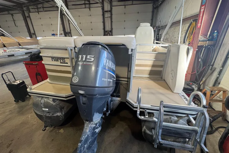 Slide: The Image of 2005 Harris FloteBote 260 Classic pontoon boat with Yamaha 115 four-stroke engine in a garage. - 18