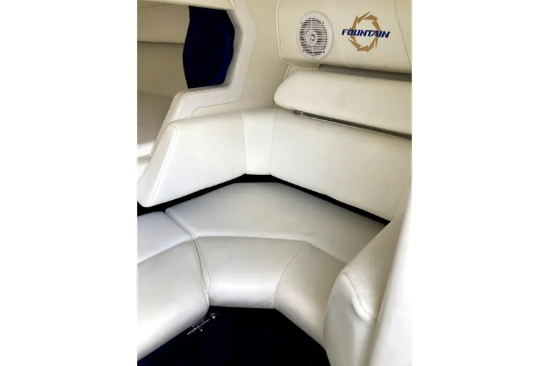 Slide: The Image of Interior of 2003 Fountain 27 Fever boat with white seating and speaker. - 12