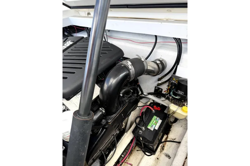 Slide: The Image of Engine compartment of a 2003 Fountain 27 Fever boat, showing battery and wiring. - 13