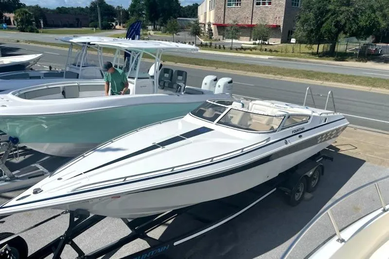 Slide: The Image of 2003 Fountain 27 Fever speedboat on trailer, parked outdoors in a lot. - 3