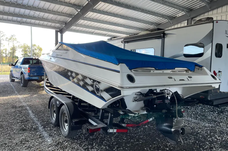Slide: The Image of 2003 Fountain 27 Fever boat on trailer, covered, parked under shelter. - 5