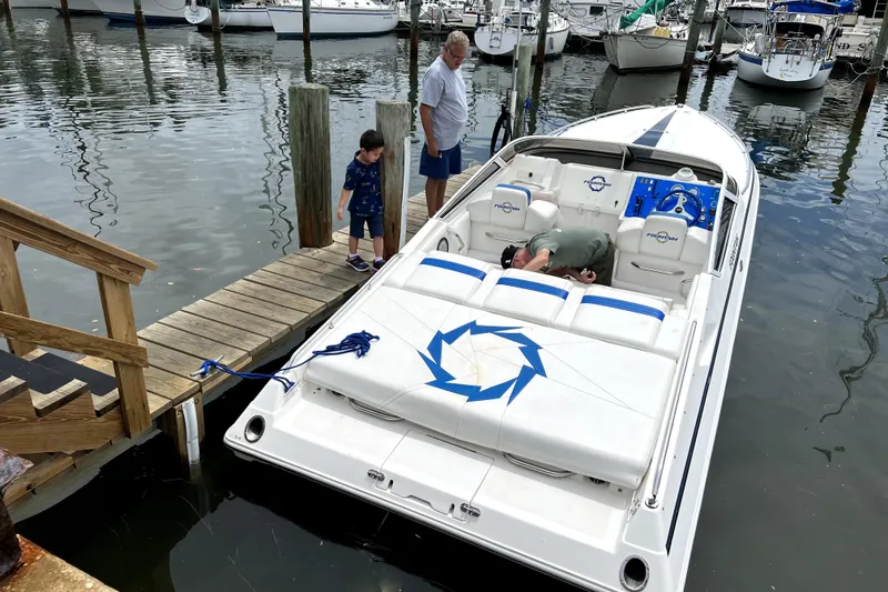 Slide: The Image of 2003 Fountain 27 Fever speedboat docked at marina with people nearby. - 6