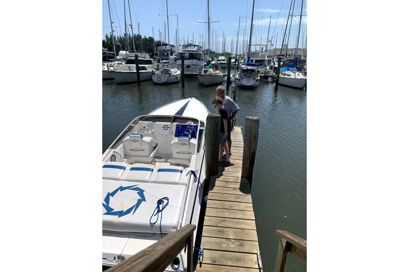 Slide: The Image of 2003 Fountain 27 Fever boat docked at marina with people on pier. - 7