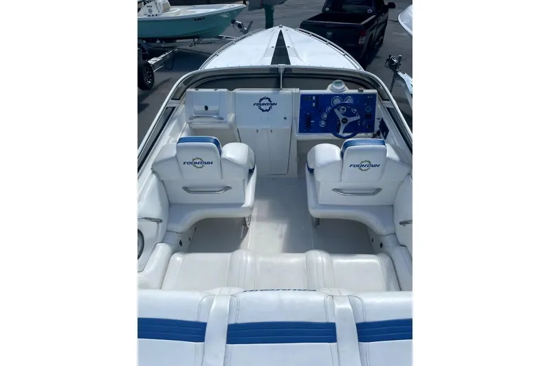 Slide: The Image of 2003 Fountain 27 Fever boat interior with white and blue seating and dashboard. - 8
